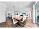Open-concept dining and living area with wood floors, modern furnishings, and sliding glass doors at 438 Marcello Blvd, Kissimmee, FL 34746