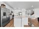 Bright kitchen features white cabinets, stainless steel appliances, and large island with bar seating at 438 Marcello Blvd, Kissimmee, FL 34746