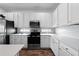 Modern kitchen with white cabinets, stainless steel appliances, light countertops and backsplash at 438 Marcello Blvd, Kissimmee, FL 34746
