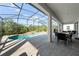 Screened lanai with a pool, outdoor dining area, and views of the backyard at 438 Marcello Blvd, Kissimmee, FL 34746