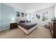 Bedroom featuring neutral paint, carpet, and a padded headboard with decorative wall art at 438 Marcello Blvd, Kissimmee, FL 34746