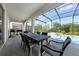 Covered patio with a dining table and pool in the background at 438 Marcello Blvd, Kissimmee, FL 34746