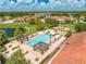Aerial view of community pool with shaded pergolas, lounge chairs, and lush landscaping at 438 Marcello Blvd, Kissimmee, FL 34746