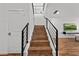 Staircase with wood steps, metal railings, and stained glass window design at the top at 438 Marcello Blvd, Kissimmee, FL 34746