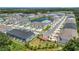 Aerial view featuring a mix of single-Gathering homes and townhomes near a pond, showcasing community layout at 4542 Cypress Cay Way, Kissimmee, FL 34746