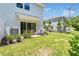 Relaxing patio in a grassy backyard offers a serene outdoor retreat with nearby building at 4542 Cypress Cay Way, Kissimmee, FL 34746