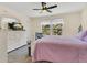 Cozy bedroom with a large bed, comfortable furniture, and large windows with a view of lush greenery at 4542 Cypress Cay Way, Kissimmee, FL 34746