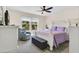 Cozy bedroom with a large bed, comfortable furniture, and large windows with a view of lush greenery at 4542 Cypress Cay Way, Kissimmee, FL 34746