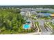Aerial view of community pool and basketball court, surrounded by lush greenery and manicured landscaping at 4542 Cypress Cay Way, Kissimmee, FL 34746