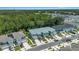 Exterior view of the new townhomes with individual driveways and garages, near a lush green space at 4542 Cypress Cay Way, Kissimmee, FL 34746