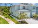 Inviting townhome featuring a private garage, lovely landscaping, and a welcoming entryway at 4542 Cypress Cay Way, Kissimmee, FL 34746