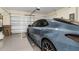 Spacious garage with epoxy floors, perfect for parking and additional storage; car with cat decal at 4542 Cypress Cay Way, Kissimmee, FL 34746