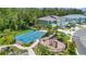 Aerial view of a community park with a playground, basketball court, and benches amid trees at 4542 Cypress Cay Way, Kissimmee, FL 34746