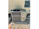 Exterior shot of a Lennox AC unit, sitting on gravel next to the house at 455 E Palmetto Ave, Longwood, FL 32750