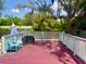 Back porch with outdoor seating, a charcoal grill, and a view of mature trees in the backyard at 455 E Palmetto Ave, Longwood, FL 32750