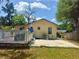 Home's backyard features a patio and a deck, perfect for outdoor gatherings and relaxation under the trees at 455 E Palmetto Ave, Longwood, FL 32750