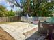 Spacious backyard with a large paved area, deck, mature trees, and an AC unit on the side of the house at 455 E Palmetto Ave, Longwood, FL 32750
