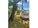 Spacious backyard with a white fenced deck and shade trees, offering privacy and outdoor enjoyment at 455 E Palmetto Ave, Longwood, FL 32750