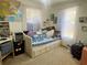 Bright bedroom featuring a daybed with lots of pillows and natural light from the two large windows at 455 E Palmetto Ave, Longwood, FL 32750