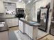 Bright kitchen with white cabinets, stainless steel appliances, and a kitchen island at 455 E Palmetto Ave, Longwood, FL 32750