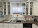 Bright kitchen featuring ample cabinet space, white subway tile, and granite countertops at 455 E Palmetto Ave, Longwood, FL 32750