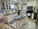 Stylish kitchen boasting granite countertops, white cabinetry, and stainless-steel appliances at 455 E Palmetto Ave, Longwood, FL 32750