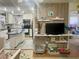 Cozy living area featuring hardwood floors with a view of the kitchen with white cabinets at 455 E Palmetto Ave, Longwood, FL 32750