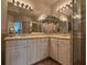 Bright bathroom featuring double sinks, framed mirrors, and tiled flooring in neutral tones at 501 Mirasol Cir # 203, Celebration, FL 34747