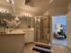Bright bathroom showcases a glass enclosed shower, with neutral wall paint, and tile flooring at 501 Mirasol Cir # 203, Celebration, FL 34747