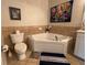 Bathroom features a corner soaking tub, tiled walls, neutral paint, and tile flooring at 501 Mirasol Cir # 203, Celebration, FL 34747