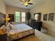 Spacious bedroom with a decorative headboard, windows, and a comfortable bed at 501 Mirasol Cir # 203, Celebration, FL 34747