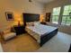Inviting bedroom with large windows, dark furnishings, and a cozy atmosphere at 501 Mirasol Cir # 203, Celebration, FL 34747