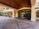 Building entrance with brick driveway, well manicured palms, and glass encased entrance doors at 501 Mirasol Cir # 203, Celebration, FL 34747