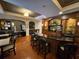 Resident community space, featuring a coffee bar, tables, and seating in warm tones at 501 Mirasol Cir # 203, Celebration, FL 34747