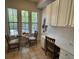 Charming dining area with natural light, a glass table, and adjacent workspace at 501 Mirasol Cir # 203, Celebration, FL 34747