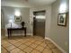 Residential lobby with decorative table and art, leading to elevator access for residents at 501 Mirasol Cir # 203, Celebration, FL 34747