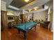 Community game room with billiard table, comfortable seating, and decorative lighting at 501 Mirasol Cir # 203, Celebration, FL 34747