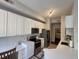 Modern kitchen with white cabinetry, stainless steel appliances, and ample counter space at 501 Mirasol Cir # 203, Celebration, FL 34747