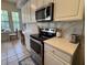 Well-lit kitchen area featuring stainless steel appliances, and a nearby breakfast table at 501 Mirasol Cir # 203, Celebration, FL 34747