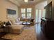 Relaxing living room featuring a plush sectional sofa, large windows, and stylish decor at 501 Mirasol Cir # 203, Celebration, FL 34747