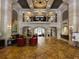 Luxury lobby with travertine tile flooring, elegant seating, columns, and decorative ironwork at 501 Mirasol Cir # 203, Celebration, FL 34747