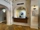 Reception desk featuring travertine columns, stone archway, and accent lighting at 501 Mirasol Cir # 203, Celebration, FL 34747