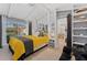 Bright bedroom featuring a yellow comforter, ceiling fan, closet, shelves, and view of a pool at 5053 Maui Cir # 14, Orlando, FL 32808
