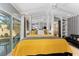 Bright bedroom featuring a yellow comforter, ceiling fan, closet, and sliding glass doors leading to the outside at 5053 Maui Cir # 14, Orlando, FL 32808