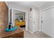 Bright bedroom with a yellow comforter, closet, and access to the entryway with a tray on a wooden shelf at 5053 Maui Cir # 14, Orlando, FL 32808