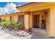 Inviting front entrance with a well-maintained landscape and a charming, covered porch at 5053 Maui Cir # 14, Orlando, FL 32808