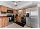 Efficient kitchen features wood cabinetry, stainless steel appliances, and a functional layout at 5053 Maui Cir # 14, Orlando, FL 32808