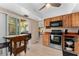 Cozy kitchen with wood cabinets and stainless appliances, connects seamlessly to the outdoor patio at 5053 Maui Cir # 14, Orlando, FL 32808