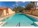 Large outdoor pool with clear water and well-maintained deck area, surrounded by lush landscaping and charming buildings at 5053 Maui Cir # 14, Orlando, FL 32808