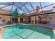 The screened-in pool area surrounded by chairs and tables at 5053 Maui Cir # 14, Orlando, FL 32808